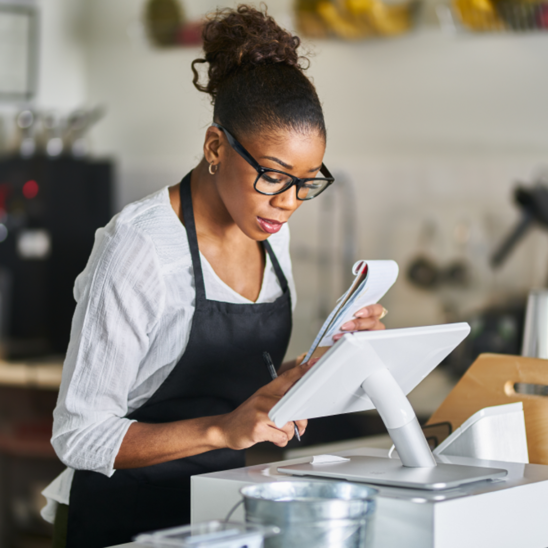 Hospitality Worker Using a Cash Register Tablet Performing HR Tasks